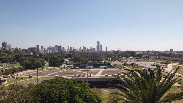 Static aerial shot of the Buenos Aires urban landscape, featuring the Law Faculty building, Plaza de las Naciones Unidas, and the city skyline