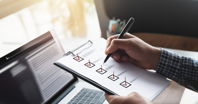 Compliance reviewer checking employee screening checklist