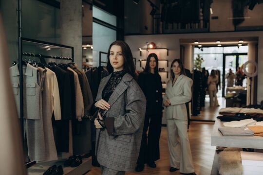 Women shopping for modern fashionable suits in boutique