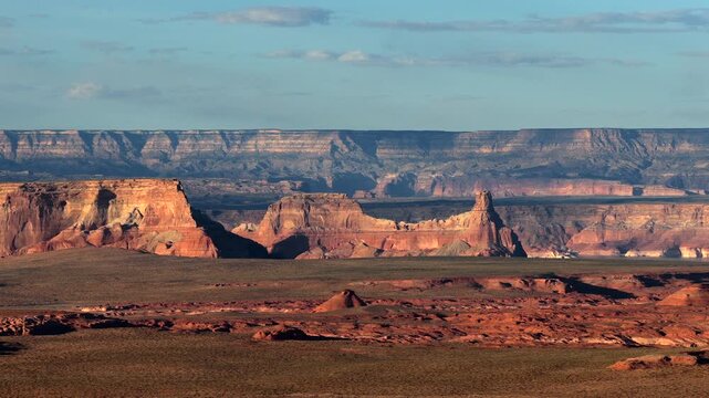 Drone view of a natural sandstone monolith outside Page, Arizona. This rugged geological structure offers a stark, southwest sci-fi aesthetic for travel documentaries and otherworldly film media.