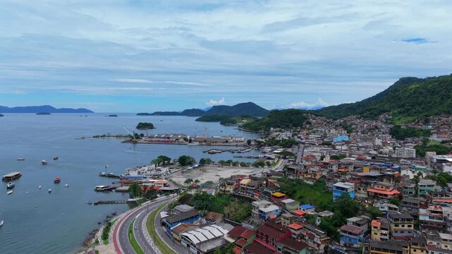 A sweeping drone pan over the coastal city of Angra dos Reis, showing the harbor and coastline.