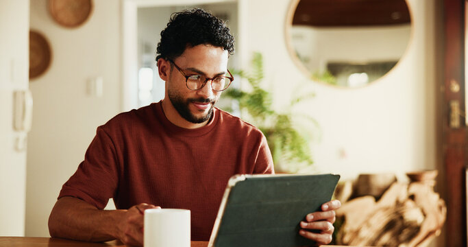 Morning, coffee and man in home with tablet, online blog post and glasses for reading breaking news. Person, tea and digital tech in house with social media update, connection or website for article.