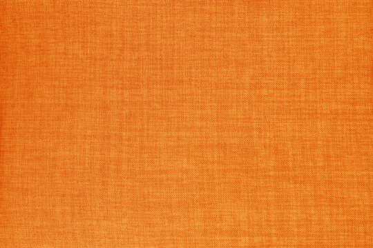 Orange linen fabric cloth texture for background, natural textile pattern.