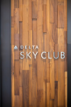 Delta Sky Club sign on wooden wall paneling in Detroit.