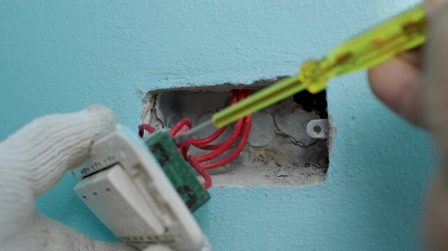 Using a voltage tester screwdriver to check the wires.