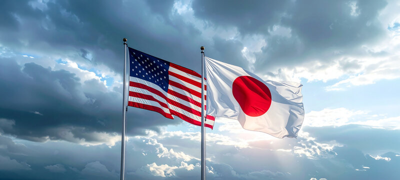 強風の空で関係性を象徴する日米国旗の躍動