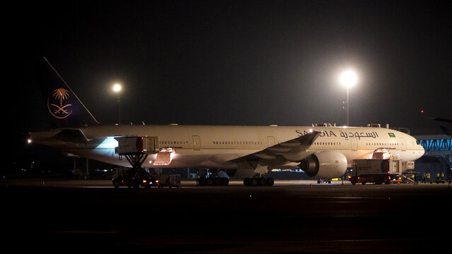 Side view of a large commercial jet aircraft Garuda Indonesia preparing for departure at the airport terminal at night on April 22, 2026 in Soekarno-Hatta Interational Airport, Jakarta, Indonesia.