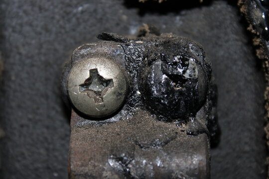 Comparison of a clean and a soot-covered bolt from a heating boiler