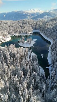 Caumasee Lake Cauma in Flims, Switzerland during winter aerial drone vertical video reel