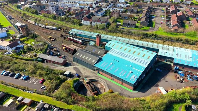 4K 60FPS aerial video of Whitehead Railway Museum in Whitehead, County Antrim, Northern Ireland in the UK on a sunny day. Produced with Rec709 color.