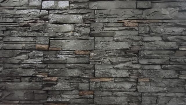 Modern artificial slate stone panels are professionally installed on an interior wall. This textured grey surface adds a sophisticated and rugged aesthetic to the room.
