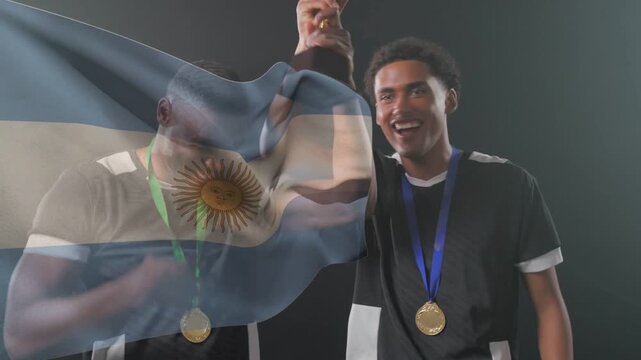 Two athletes fist-bumping, lifting trophy and celebrating win as Argentina flag overlay drifting