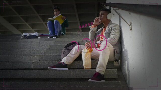 Man on stairs taking call reaching into bag pulling juice drinking pink HUD marking hands education