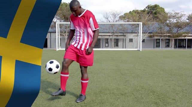 Male player dropping ball, juggling feet by goal with Swedish flag overlay fixed left for training
