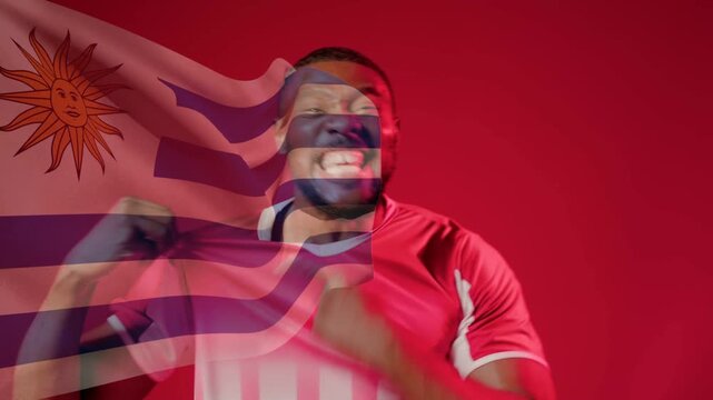Ghosted flag moving over red backdrop causing man adjusting sports jersey flexing celebrating team