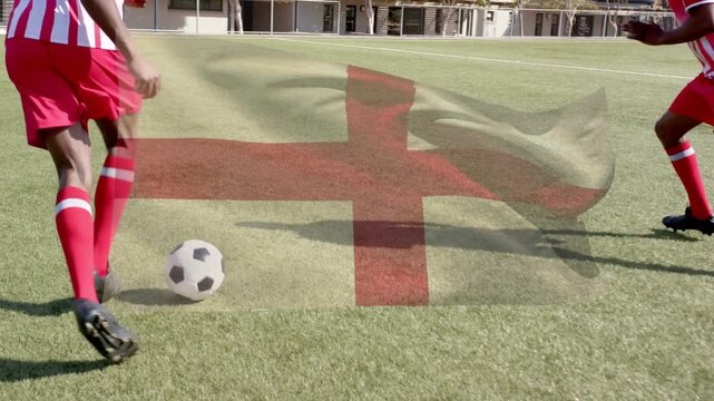 Two soccer players training right player stepping tapping ball dribbling left flag covering center
