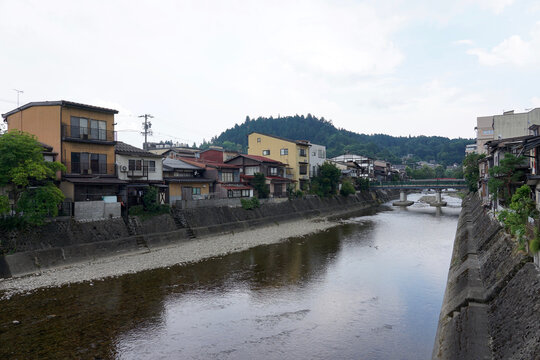  Quiet Riverside Town With Traditional Japanese Houses Along a Calm River and Small Bridge
