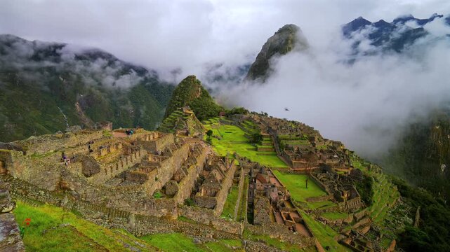 Peru's Machu Picchu World heritage site sanctuary Inca Temple early morning landscape view low cloud dense fog layer Huayna Picchu Mountain Inca Trail Circuit Aguas Calientes Peruvian Andres Mountains