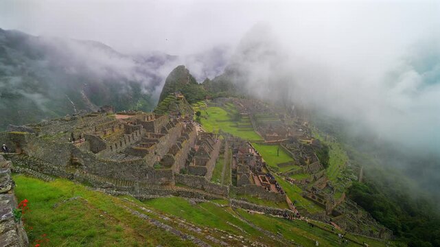 Peru's Machu Picchu landscape morning dense fog layer clouds Inca Trail Temple Huayna Picchu Mountain Circuit World heritage site sanctuary lookout terrace Peruvian Andres Mountains pan right