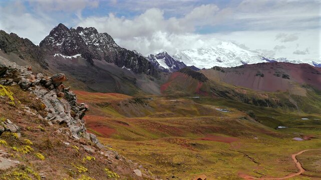 Peru's Vinicunca Rainbow Mountain  landscape view of Ausangate Glacier Peruvian Andes Vilcanota Range mountains near Quelccaya Ice Caps r sunny blue sky morning clouds valley panorama scenery forward