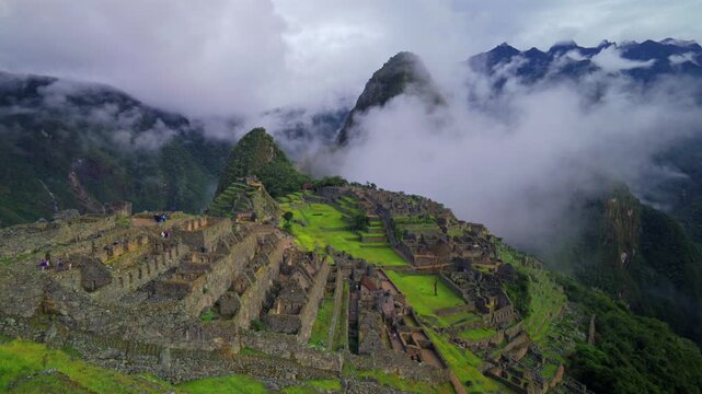 Peru's Machu Picchu World heritage site sanctuary Inca Temple early morning landscape low clouds fog layer Huayna Picchu Mountain Inca Trail Circuit Aguas Calientes Peruvian Andres Mountains zoom in