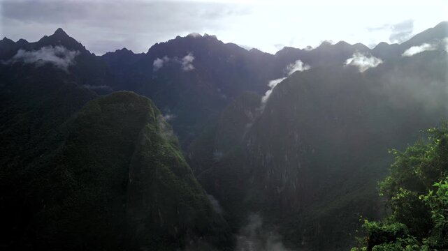 Machu Picchu Pueblo lookout Peruvian Andres highlands jungle Mountains Aguas Calientes Peru landscape early morning sunrise fog layer clouds Inca Trail Temple Vilcanota Urubamba River static shot
