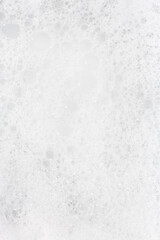 Fototapeta premium Bubbling foam creating an opaque surface in a serene setting during the daytime