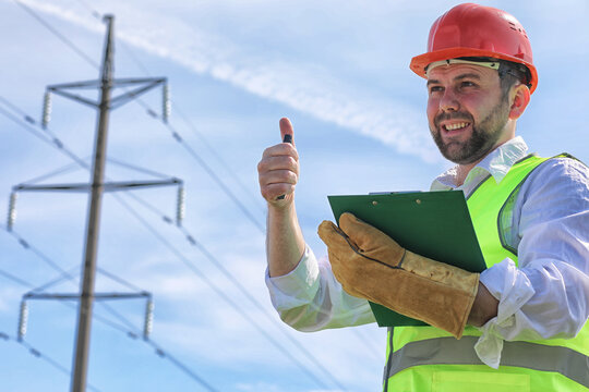 Electrician working in a helmet wearing gloves