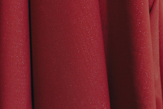 Close-up of Crimson Red Pleated Cloth with Subtle Shimmer, Luxury Fashion Textile Texture