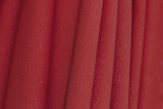 Close-up of Crimson Red Pleated Cloth with Subtle Shimmer, Luxury Fashion Textile Texture