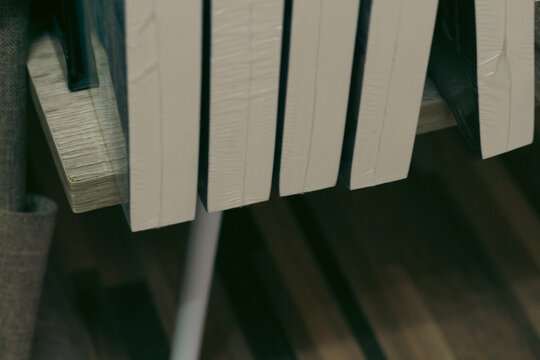 Close-Up of Beige Book Spines Wrapped in Clear Plastic, Minimal Library Book Collection Background