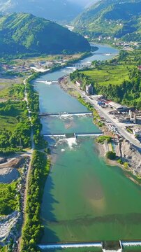 Vertical video. Ardeshen, Turkey. Panorama of green mountains. Firtina River Valley. River rapids. Sunny morning. Aerial View, MasterShots, Circle (Far). Rich colors