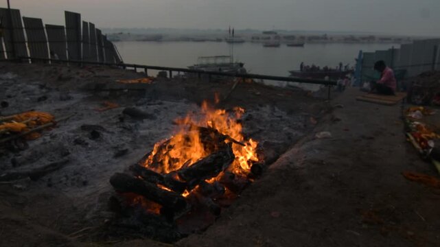 Hindu cremation ritual at Manikarnika Ghat with funeral pyre burning in Varanasi