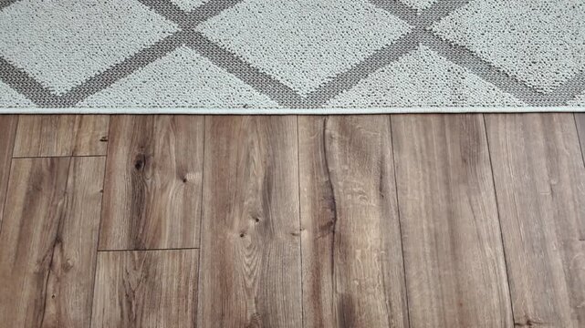 Natural wood laminate parquet floor. Room with floating laminate in new apartmen. Cozy home interior, modern design