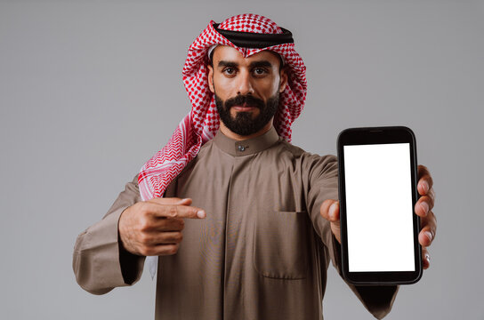 Arab man pointing at blank smartphone screen for message