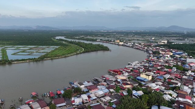 Drone footage showing Sungai Udang river bend, aquaculture ponds and riverside village in Penang, Malaysia.