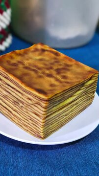 Indonesian Lapis Legit Layer Cake or Spekkoek on White Plate, Traditional Authentic Thousand Layers Spiced Butter Cake for Festive Celebration, Eid Al-Fitr, Lunar New Year, Food Photography Concept