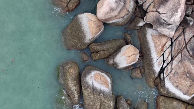 Aerial drone view of granite rocks at beach
