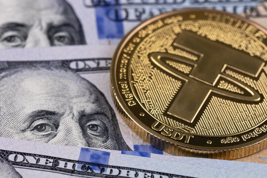 USDT, Tether cryptocurrency symbol and dollars closeup. Tether is a cryptocurrency token issued by Tether Limited. Batumi, Georgia - March 20, 2026