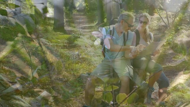 Hikers tapping smartphone and holding map, orienting travel route while leaves drifting