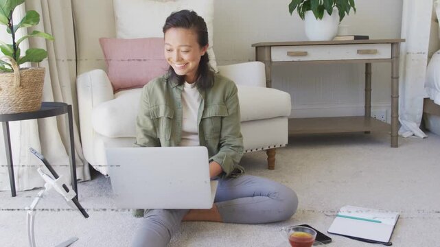 Glitch bands clearing over her, woman working laptop, typing, checking notebook for remote work