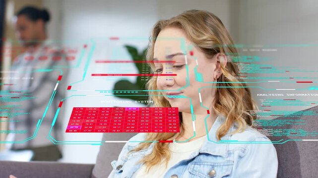 Seated woman gazing down tech holo UI rising before her red grid reviewing smiling turning right