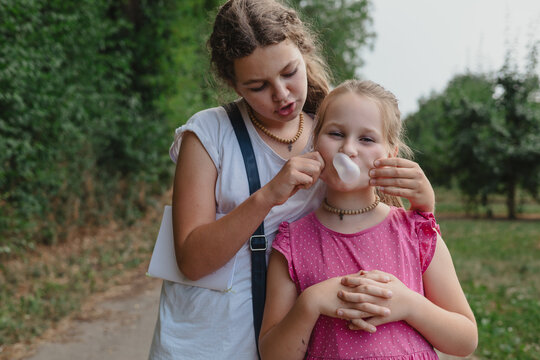 Preteen sisters walking in orchard