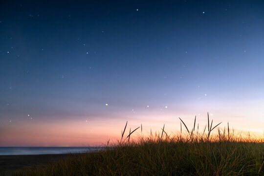 Blurry Stars come out at night after sunrise at the beach