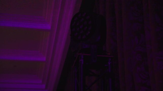 Magenta wash from par light flooding ornate ceiling and stage corner, subtle haze beams cutting through purple glow, lighting operator sculpting color for lounge performance and intimate set