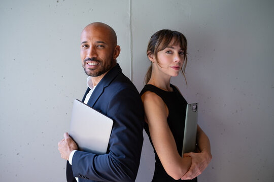 Confident business team standing back to back at the office