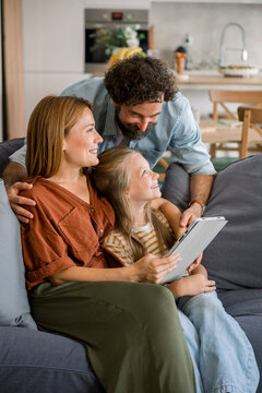 Family spending time together using digital tablet at home