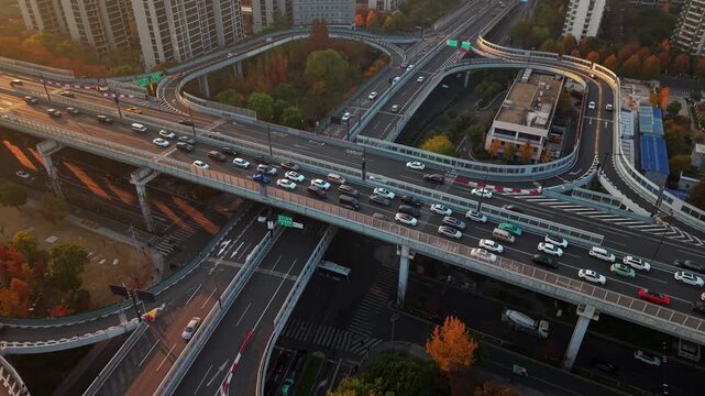 Aerial view of multilevel highway interchange with car and bus traffic in China during the sunset