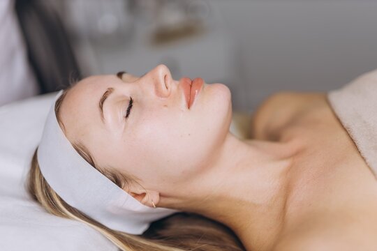 Client resting during a facial skincare treatment at the spa