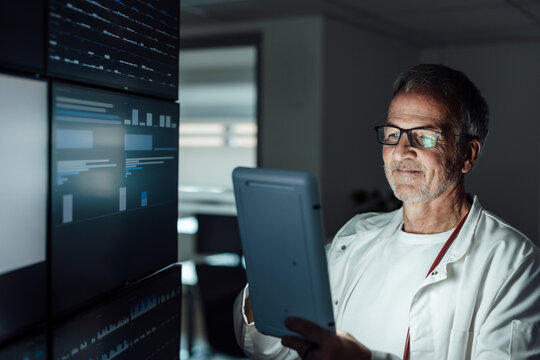 Doctor analyzing artificial intelligence data on tablet in hospital